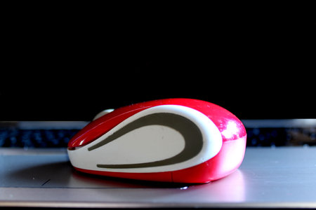 red computer mouse on the black backgroundの写真素材