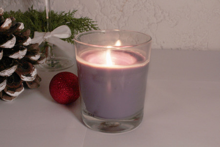 Purple candle on the table with decorationsの写真素材