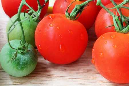red and green tomatoes on the tableの写真素材