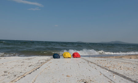 blue, red and yellow worn white shell on a wooden table
