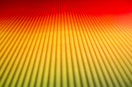 Background of Golden color, with a gradient from green to red, lines, and perspective into the distance, focus on the middleの写真素材