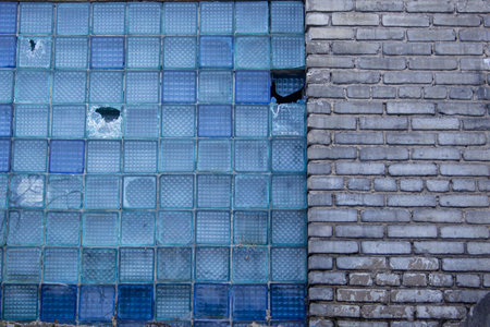 Blue mosaic tiles on the wall of the building. Abstract background.