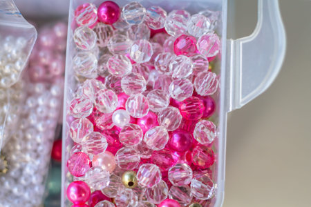 colorful beads in plastic box for sale at market, selective focus