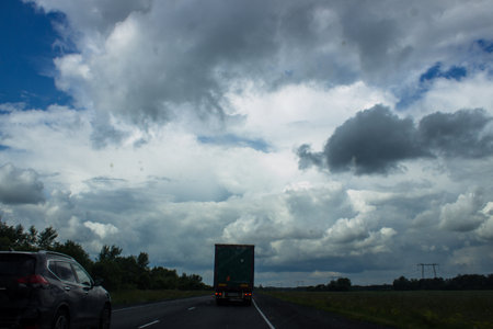 View on the road in Germany with cars and cloudy sky in the background.の写真素材