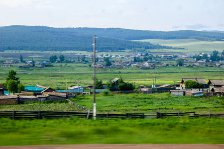 View from the car window on a village in the middle of the fieldの写真素材