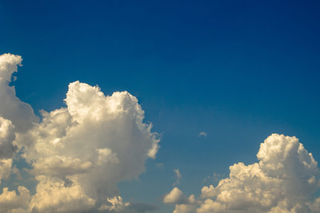 Blue sky background with white clouds. Cumulus white clouds in the blue sky.