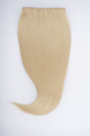 Straight blond remy virgin human hair clip in extensions on light grey backgroundの写真素材