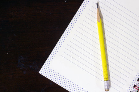 Blank book and pencil on old deskの写真素材