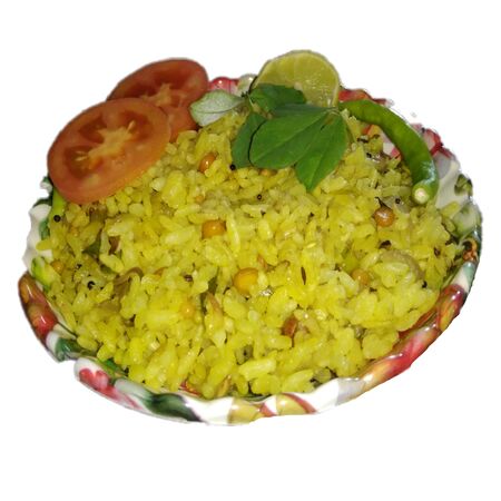 Garnished yellow rice with tomato lemon and green chilliesの写真素材