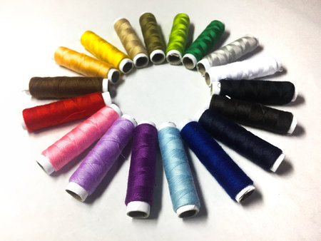 Colourful thread on white background.