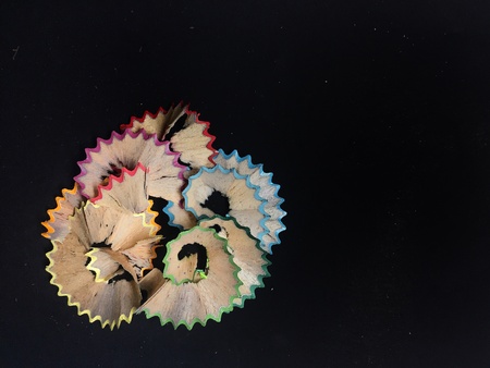 Coloured pencil shaving on black backgroundの素材