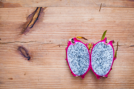 Dragon Fruit cut in half on wood backgroundの写真素材