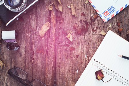notebook,pencil,glasses,airmail and dried roses on vintage backgroundの写真素材