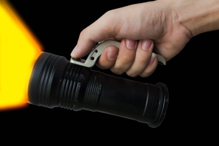 Mens hand holding a flashlight on backgroundの写真素材