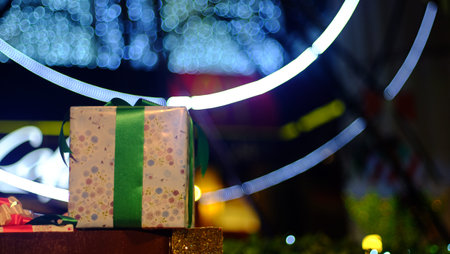 Christmas gift box decorations against lights backgroundの写真素材