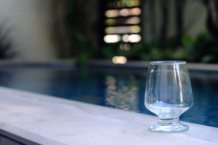 empty glass  beside the poolの写真素材