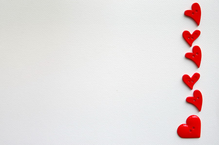 buttons shaped heart arranged on drawing paperの写真素材