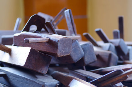 Old rusty and dirty carpenter\'s hand tools lying on wooden table