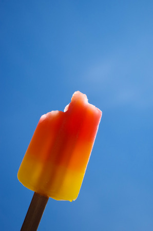 refreshing and colorful ice creams against a blue skyの写真素材