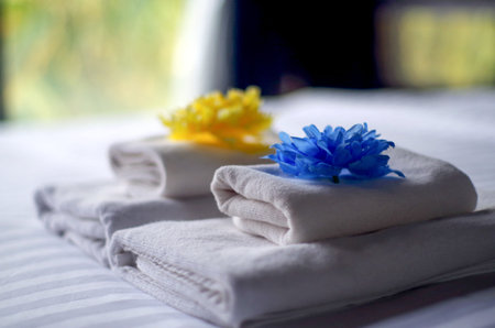 Closeup white bath towel on the bedの写真素材