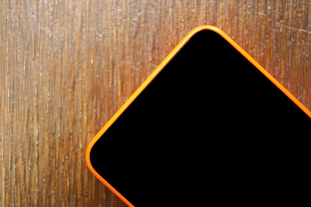 Close-up mobile, cell phone on wooden tableの写真素材