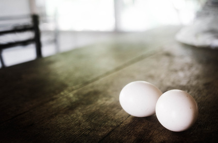 Close-up two egg lay on the wooden table, Soft focusの写真素材