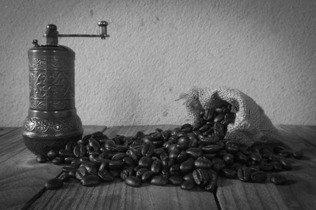 Turkish coffee grinder and little gunny-bag lay on coffee beanの写真素材