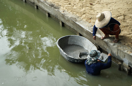 Two worker are repairing plaster to the waterlineの写真素材