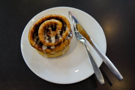 close-up Cinnamon Roll bread on white dish, Focus on Cinnamon Roll bread