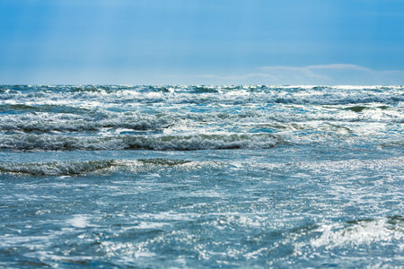 Blue sea with strong waves and blue sky with sunlight, nature backgroundの写真素材