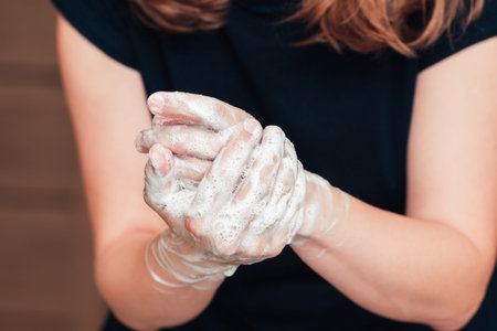 Woman washing her hands with soap foam, close upの写真素材