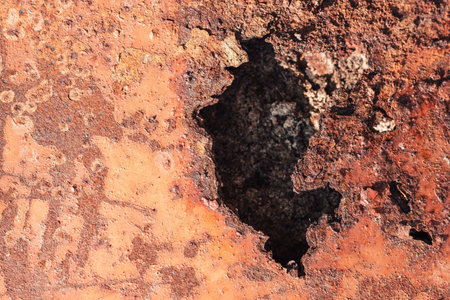 background of old rusty iron texture with a big hole with rough edges