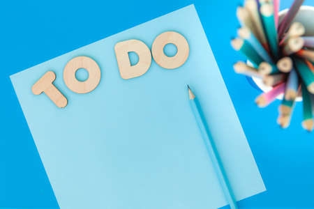 Blue sheet of paper and inscription TO DO, copyspace, top viewの写真素材