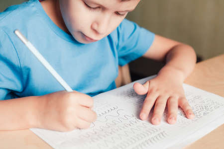 Close up of little boy doing writing practice. Children education concept.の写真素材