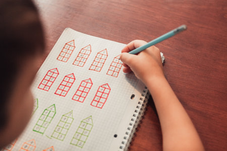 Close up view from above to schoolboy study math and doing developing creative exercisesの写真素材