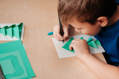 Step 7 of making Christmas card. Greeting card is almost ready. Decorate it. Child draw snowflakes...