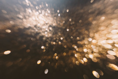 Abstract blurred Christmas background. Golden colored bokeh lights with speed motion effect