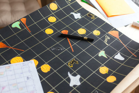 Process of making board game field for DIY Halloween game, view from above