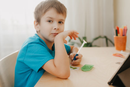 Close up of little boy creating a diamond mosaic