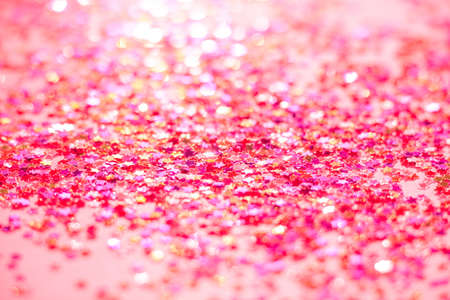 The selective focus photo of the colored confetti in the form of stars. Abstract textured background toned pink colorの写真素材