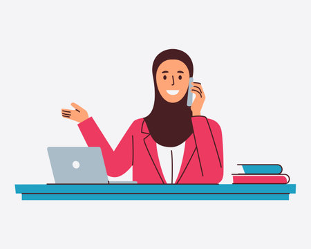 A smiling businesswoman in a hijab talks on her phone while gesturing towards a laptop on her deskのイラスト素材