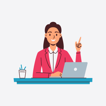 A smiling businesswoman sits at her desk working on her laptop and making a pointのイラスト素材