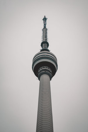 Modern Guishan TV Tower in Wuhan standing tall under grey cloudy sky with clean minimal composition.