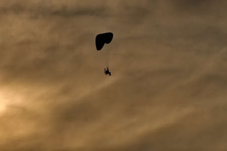 paraglider in the sky at sunsetの写真素材