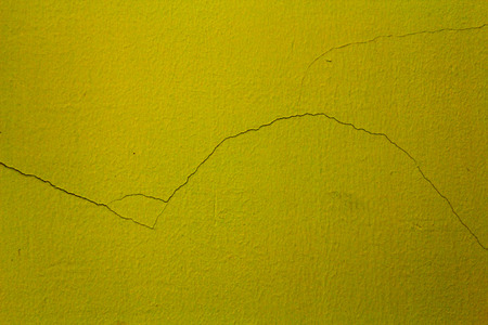 cracked on a custard cement backgroundの写真素材