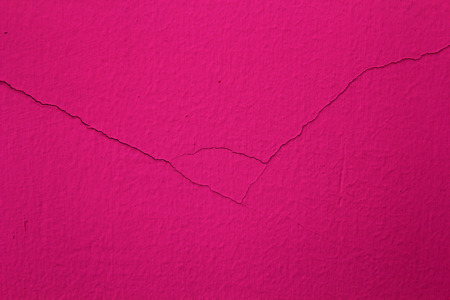 cracked on a pink cement backgroundの写真素材