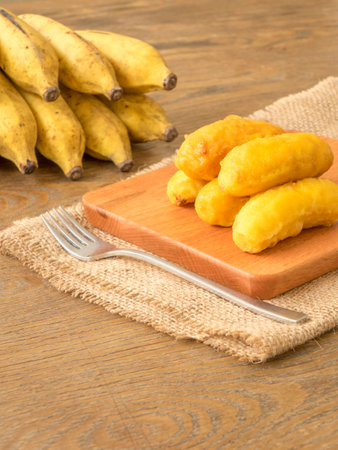 Fried banana fritters on chopping boardの写真素材