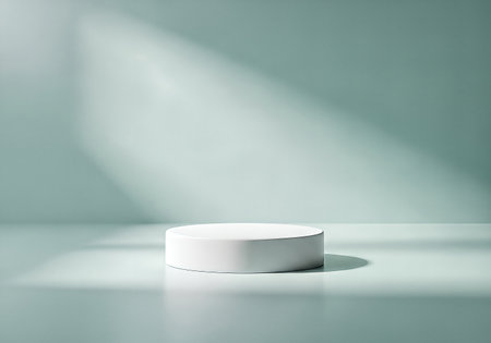 A clean, minimalist scene featuring a white cylinder podium on a soft blue surface, bathed in gentle light and shadow, creating a serene and modern aesthetic.の素材