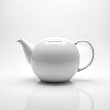 A pristine white teapot, showcasing a minimalist design, sits on a reflective white surface. Studio lighting highlights its smooth curves and elegant form.の素材