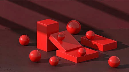 A collection of red 3D blocks and spheres on a dark surfaceの素材